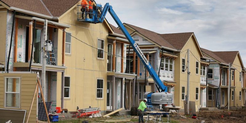 Construction workers place siding on a unit at Windsor Veterans Village in Windsor on Tuesday, February 9, 2021.  The project includes 60 affordable housing units for low-income veterans and their families.  (Christopher Chung/ The Press Democrat)